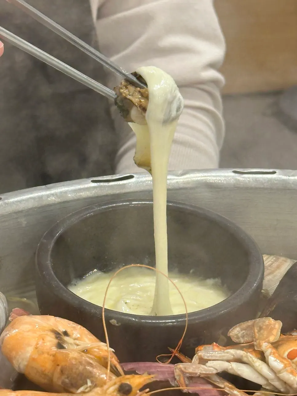 Bowl of cheese placed in the center of the hot pot