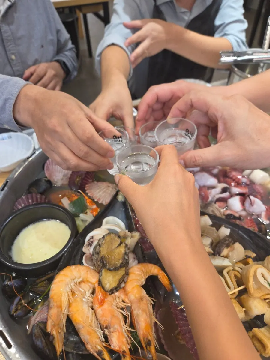 Clam broth and seafood boiling in the pot