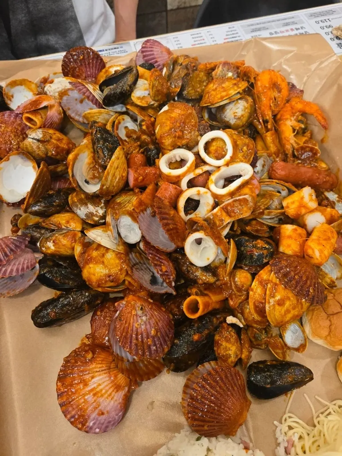 Seafood boil with pre-cut squid, rice cake, and sausage