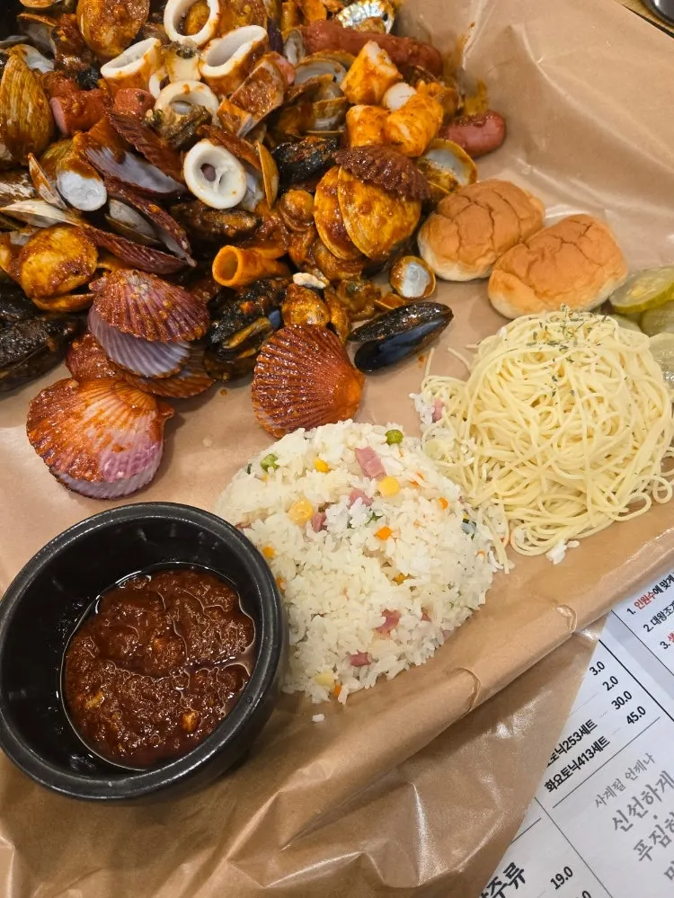 Extra sauce served with fried rice, spaghetti, and bread