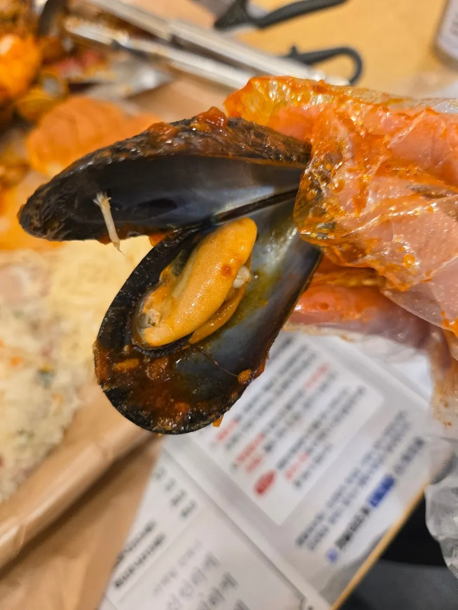 A plate of seafood arranged with sauce, ready to eat