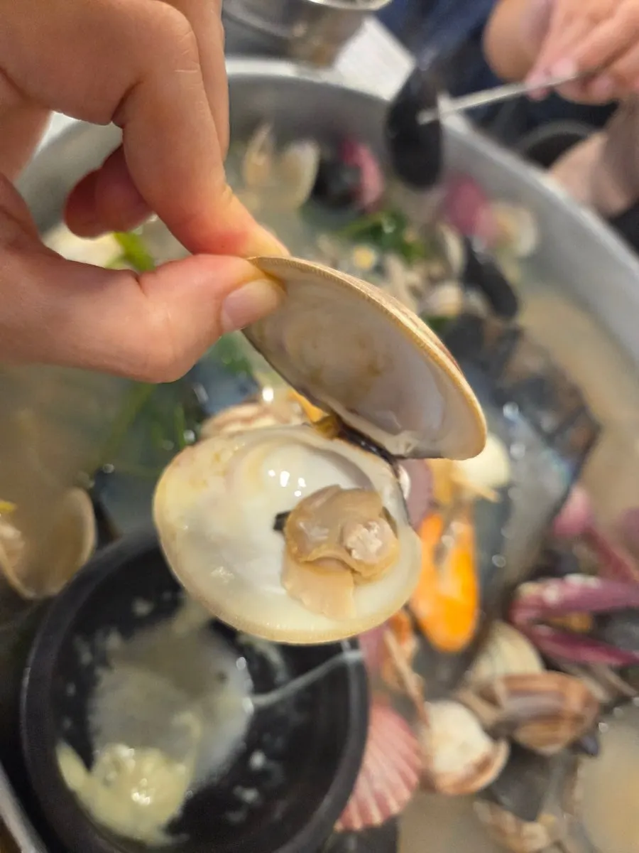 Picking up a piece of clam meat