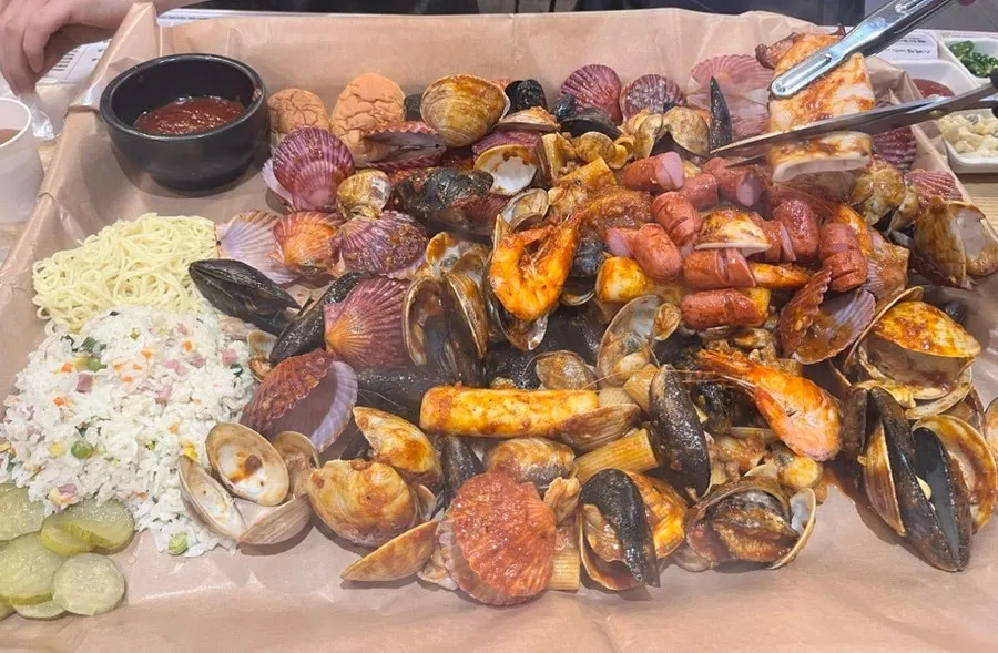 Seafood boiling with clams, mussels, shrimp, squid and abalone