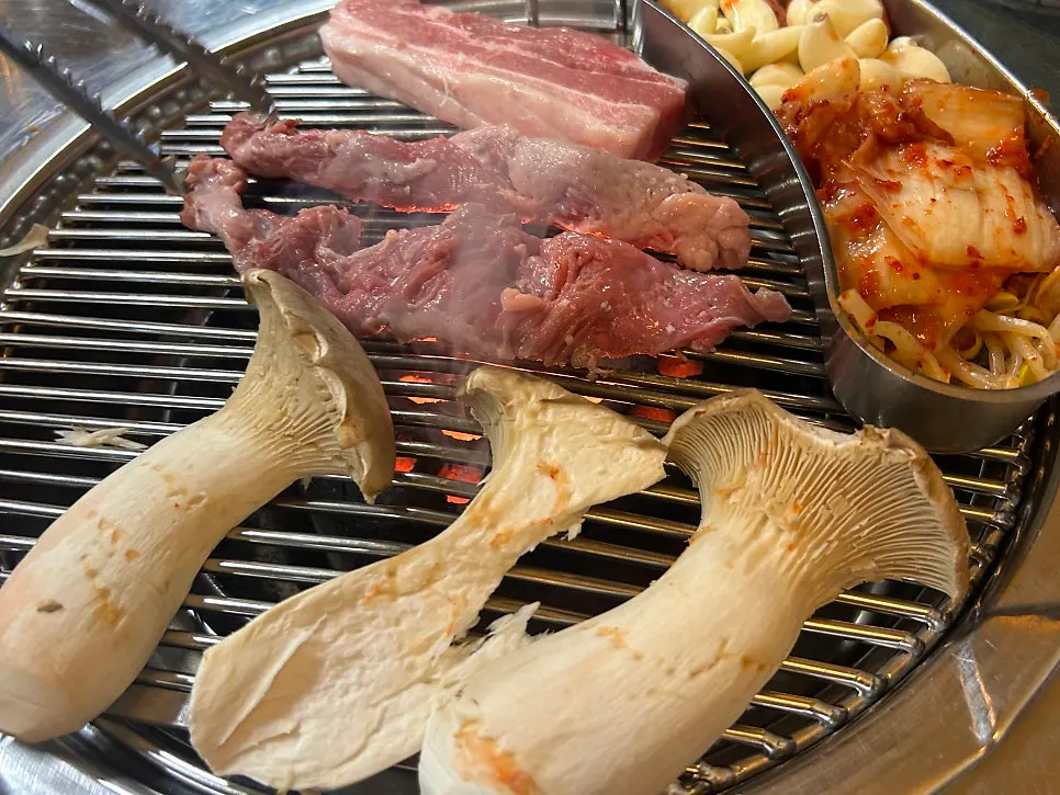 Pork belly grilling over the charcoal fire