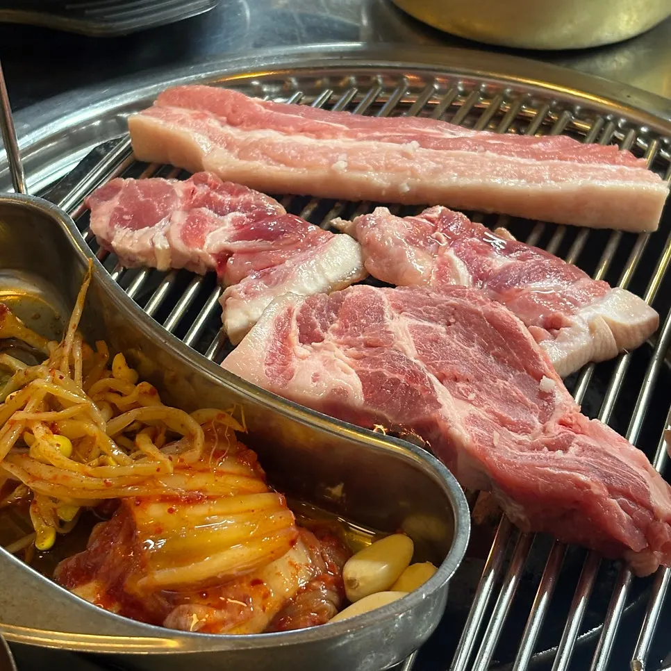 Pork placed over charcoal briquettes