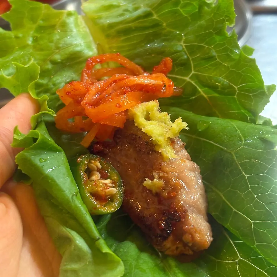 Grilled meat paired with shredded radish salad