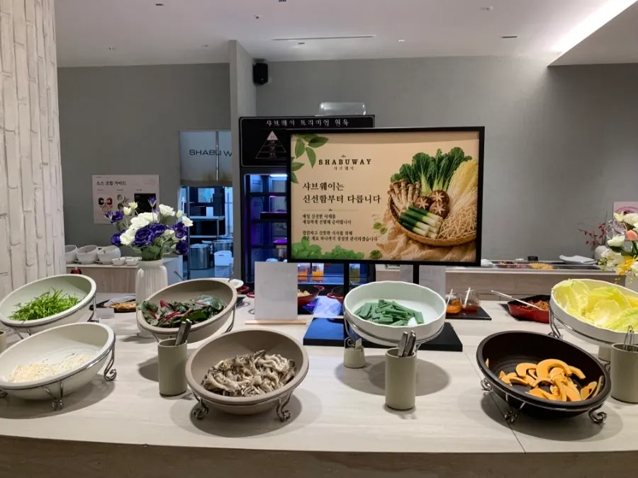 Korean side dishes and pizza at the salad bar
