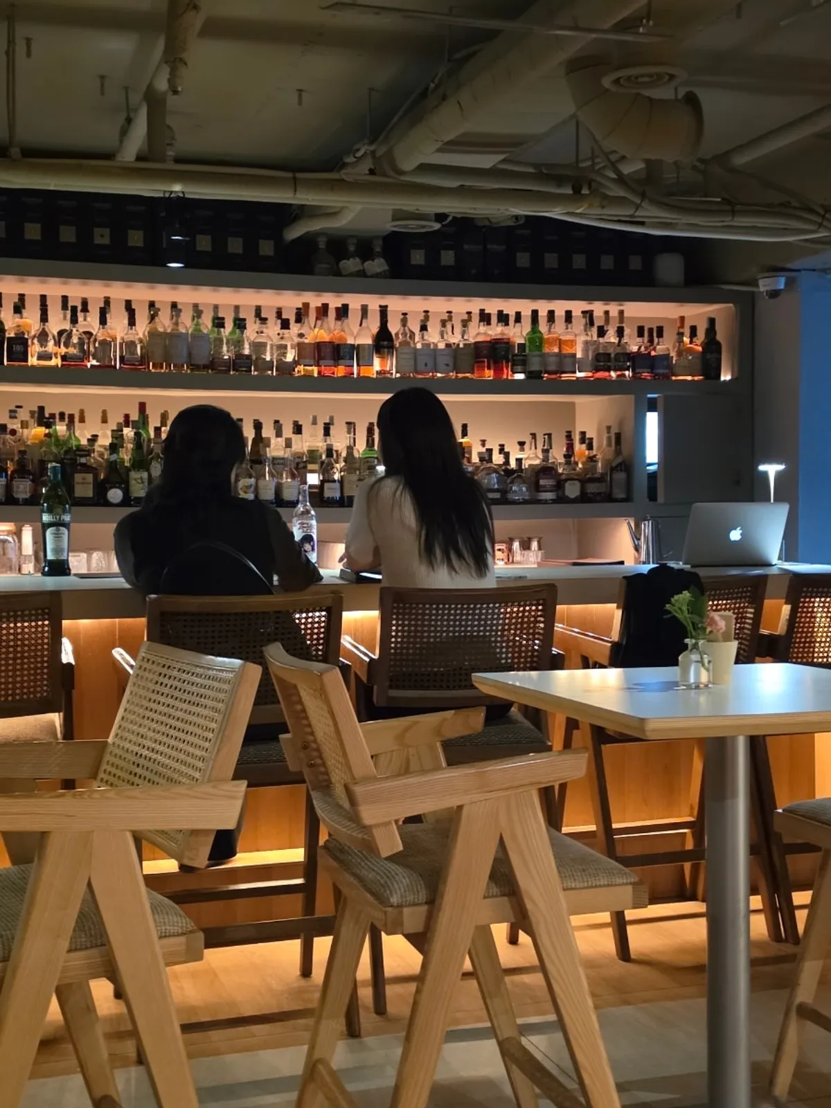 Bar table at Gak Seoul lit by a lamp