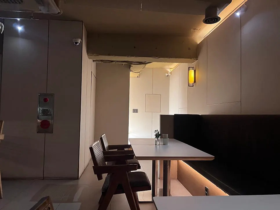 Bar counter seating and liquor display at Gak Seoul