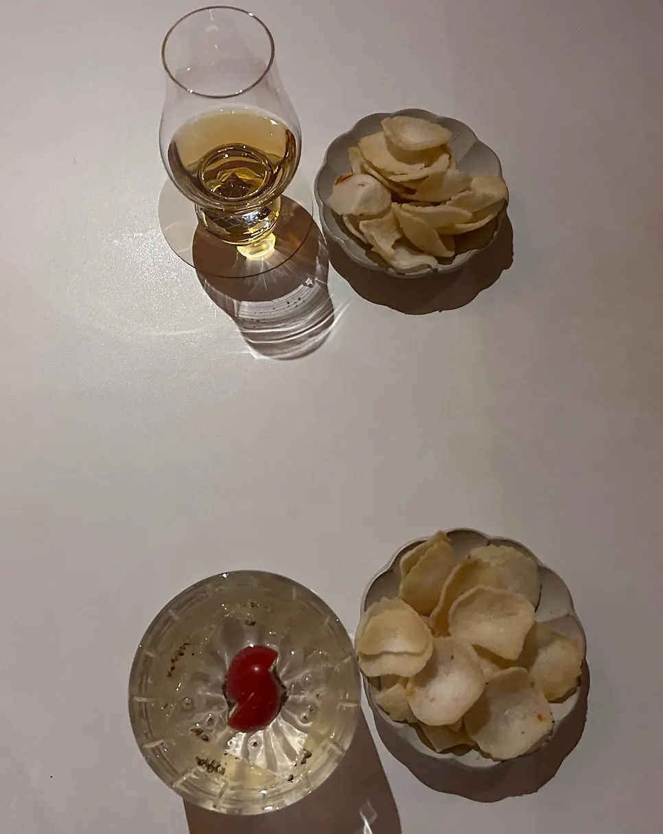 Two drinks ordered at Gak Seoul, a cocktail and a whiskey