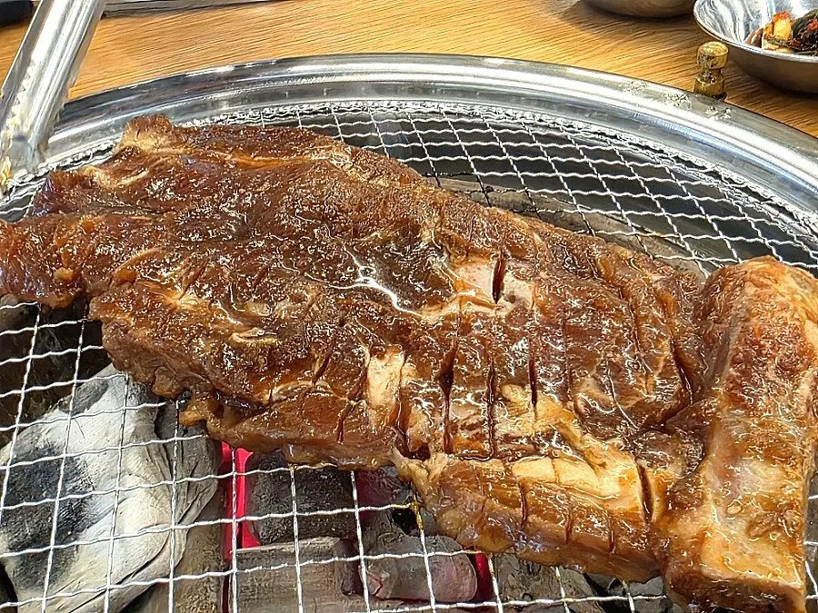 Seasoned pork ribs placed on the charcoal grill