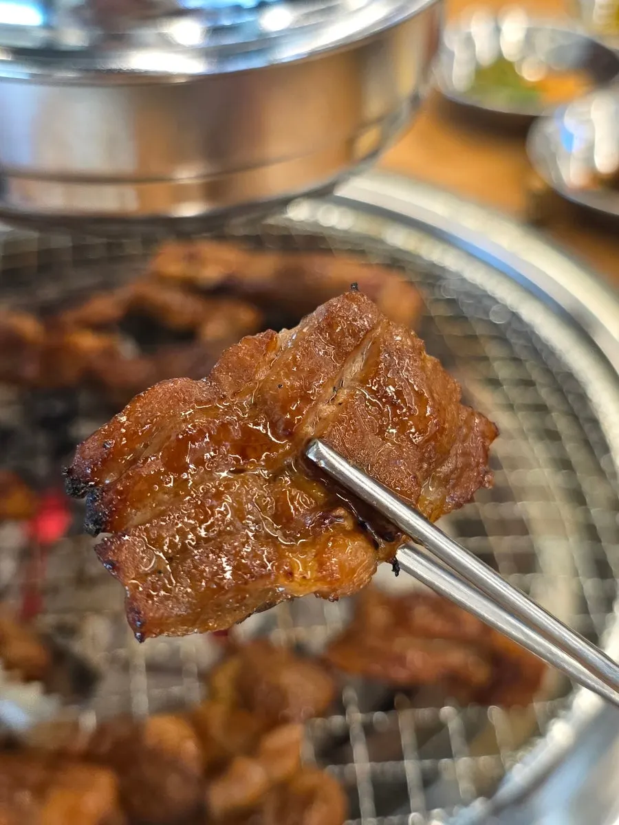 Golden-browned, 72-hour aged pork ribs on the grill