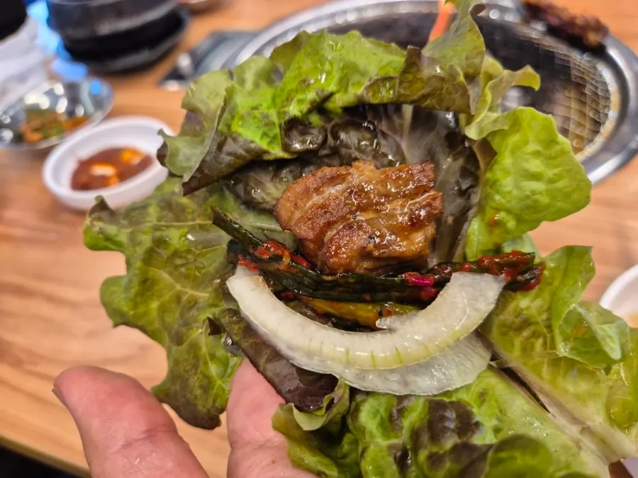 A piece of marinated rib on a perilla leaf wrap