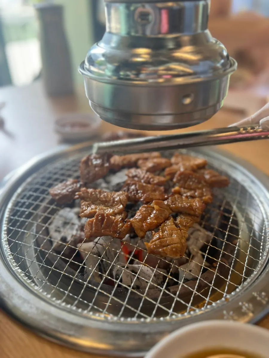 Pork ribs grilling to a golden brown over charcoal