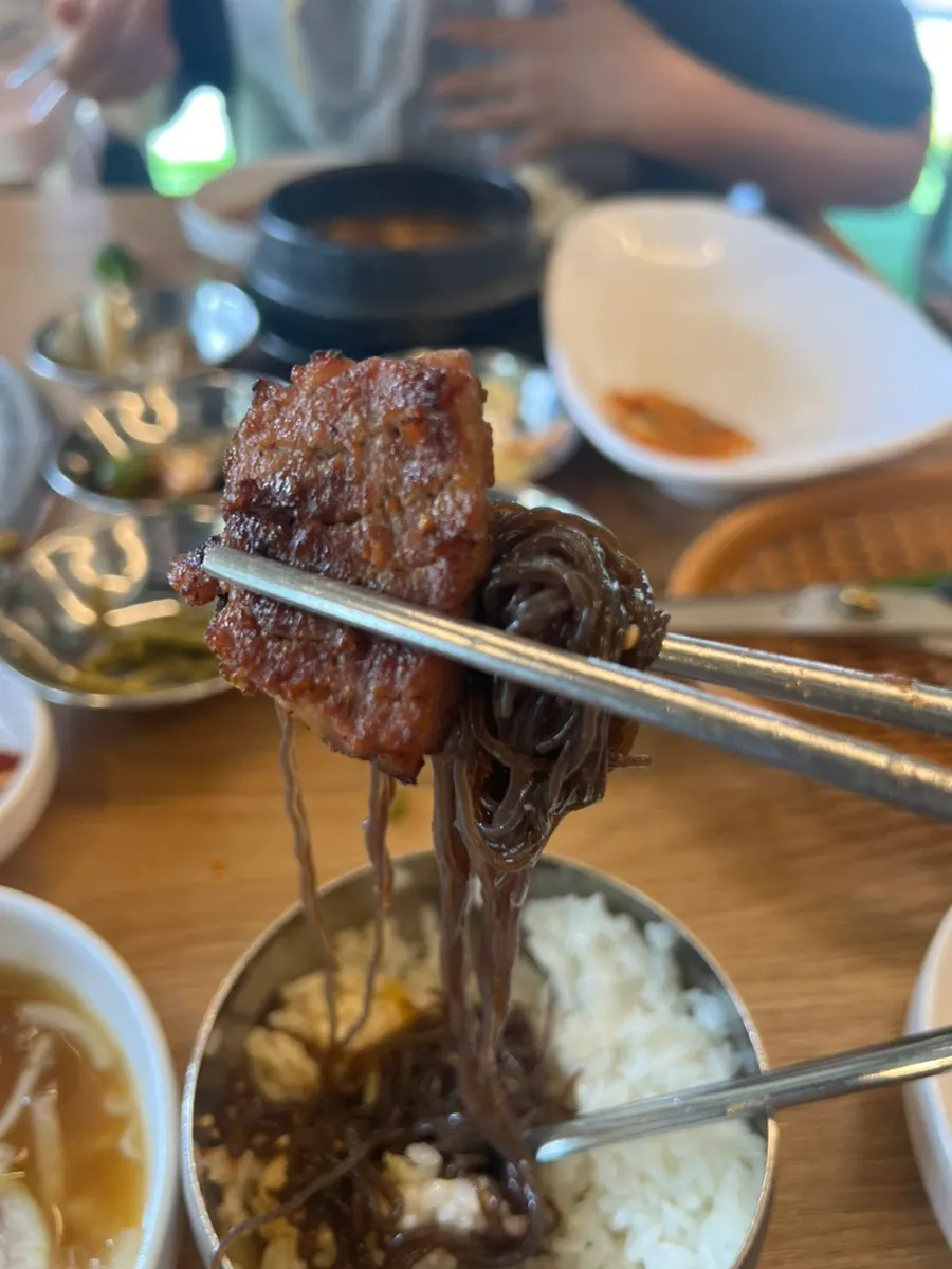 Mixed bibim naengmyeon noodles and toppings