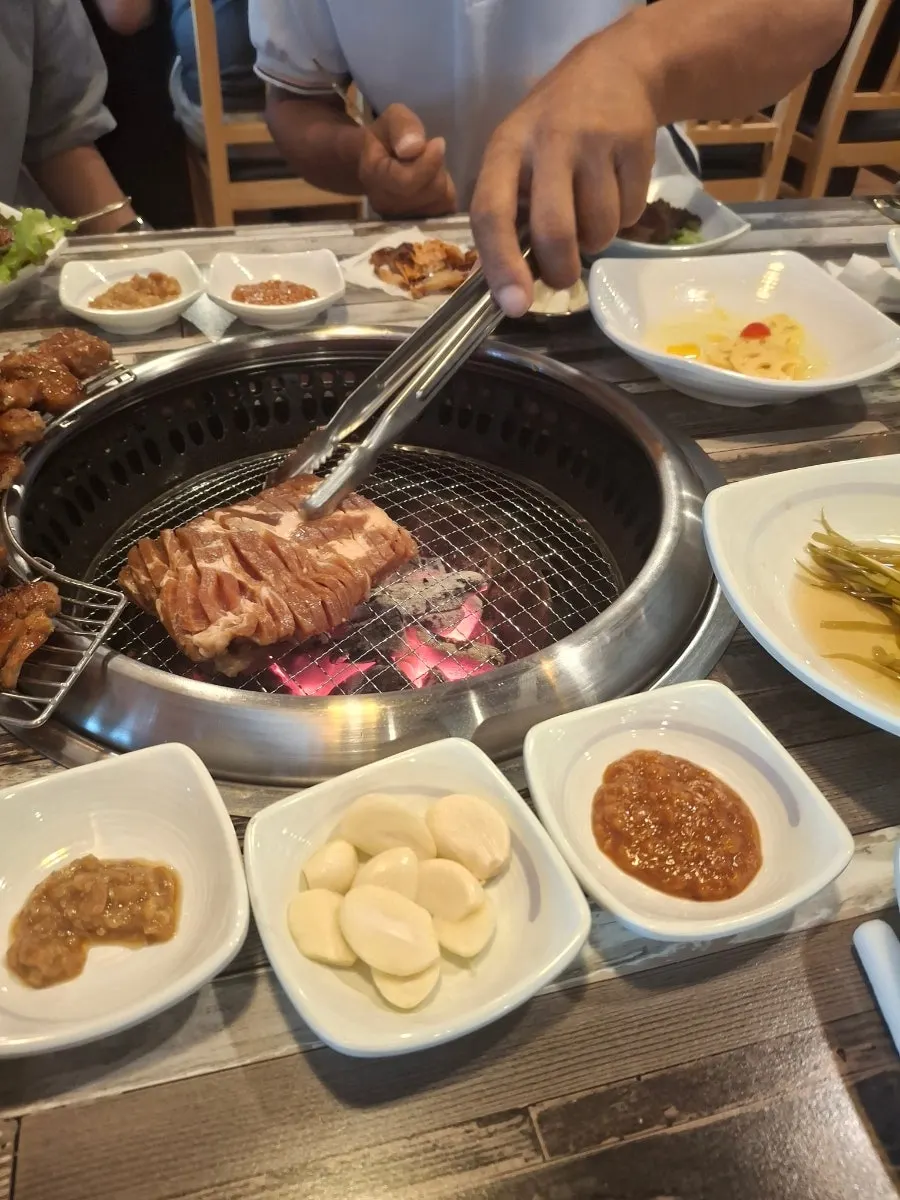 Charcoal grill releasing a sweet marinade aroma