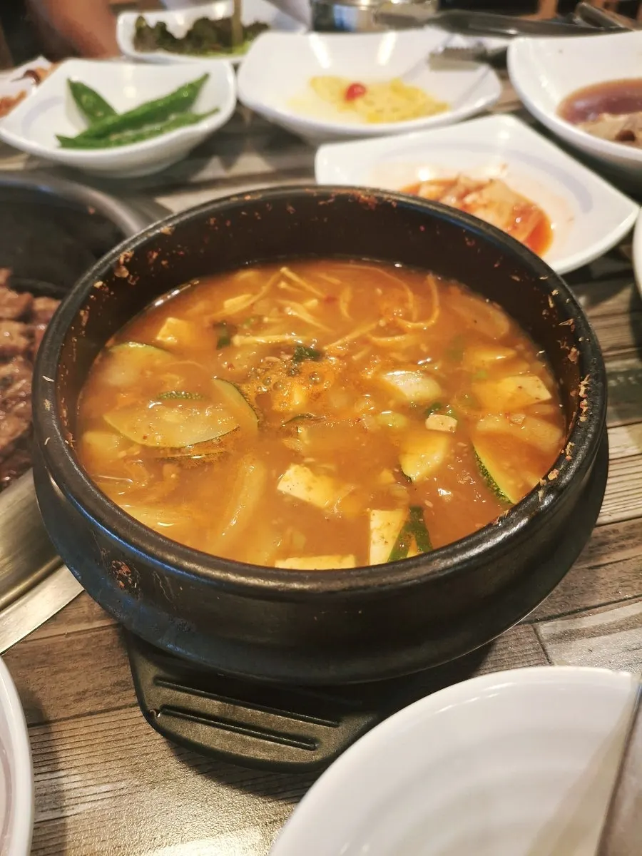 A bite of wrap with ssamjang and pickled onion