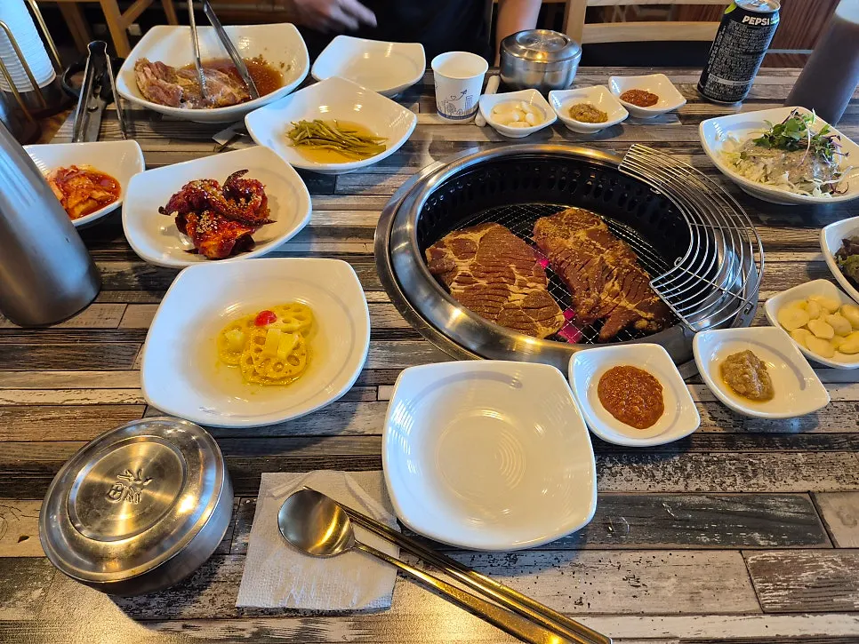 Table spread with seasoned pork ribs and side dishes