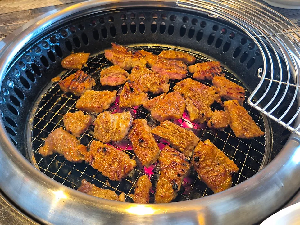 Seasoned pork ribs cooking on the charcoal grill