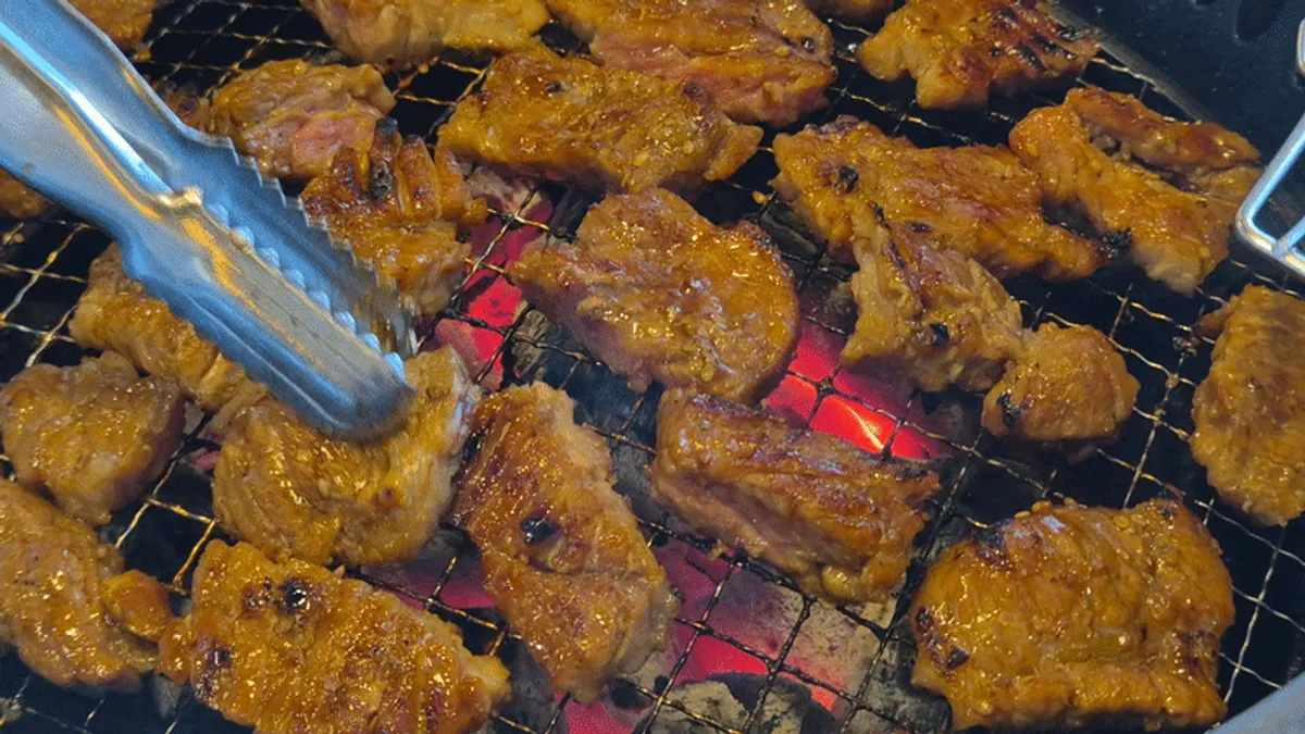 Pork ribs grilling with garlic for round two