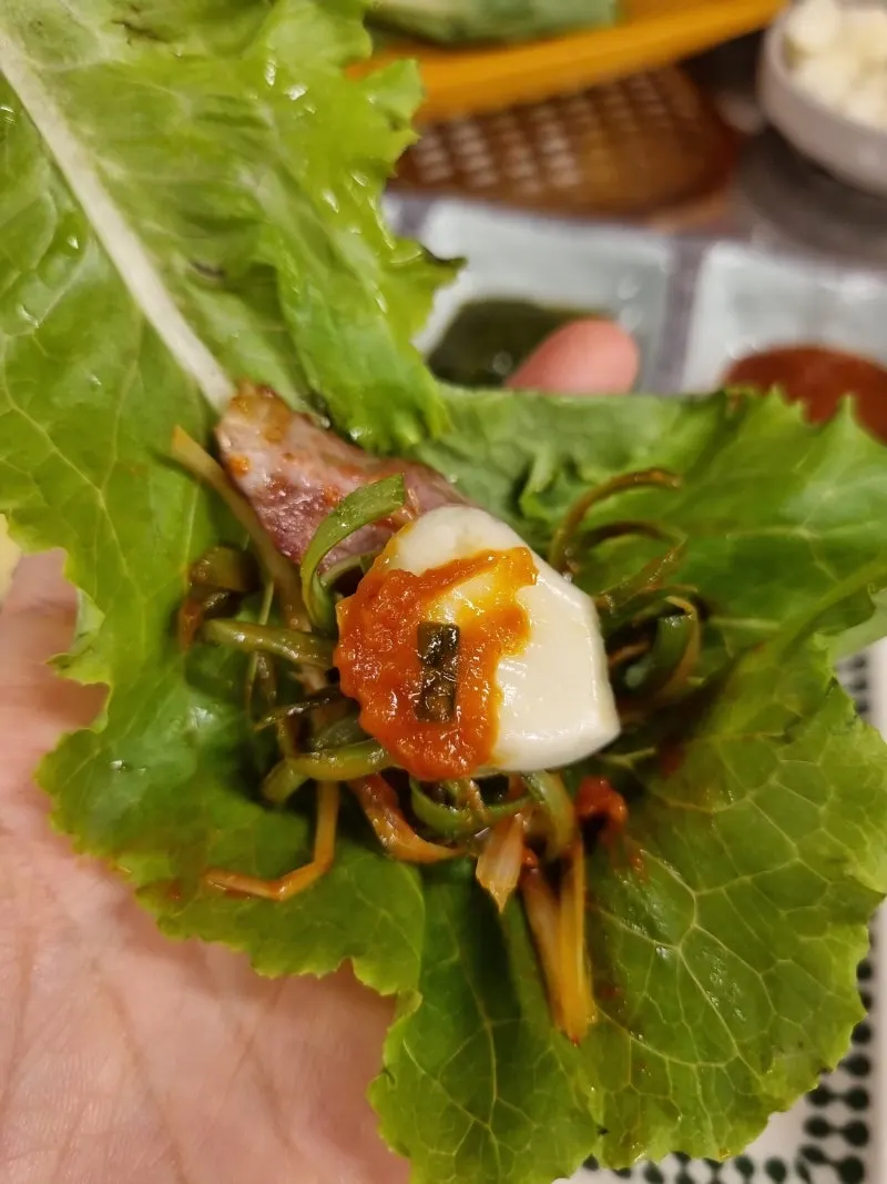 A bite of meat topped with pickled peppers