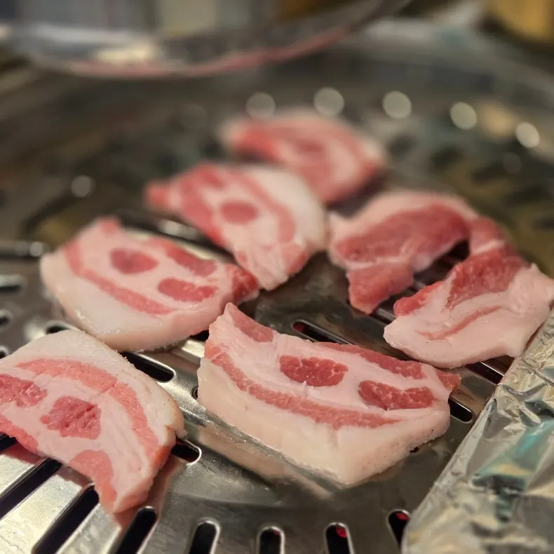 Charcoal wangsogeum pork belly served in an earthenware pot