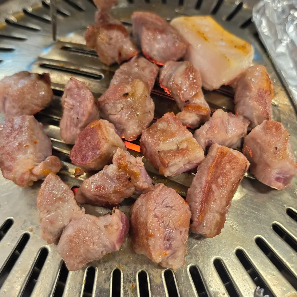 Pork neck turning golden brown on the grill