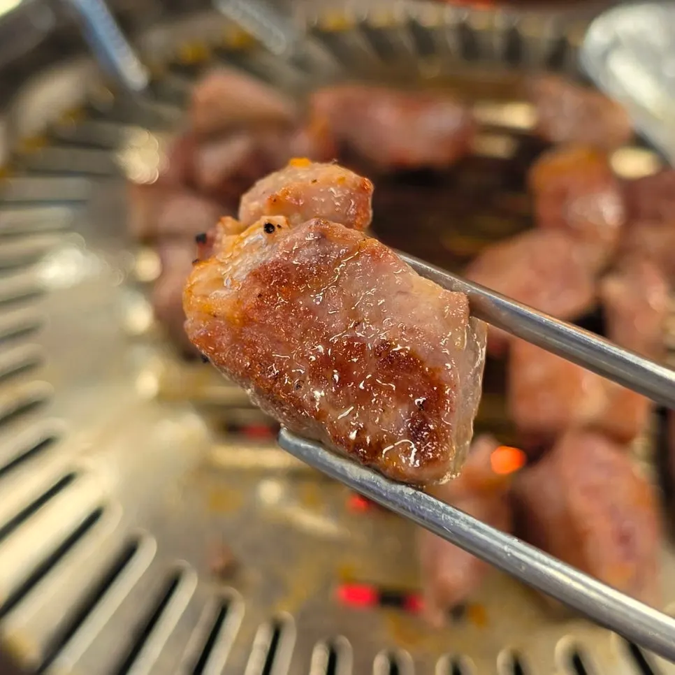 Fully cooked meat moved aside on the grill