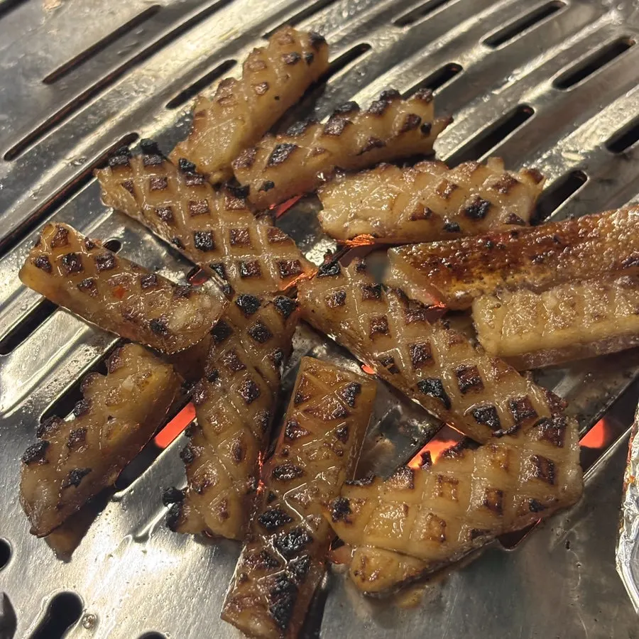 Pork skin grilling over the charcoal