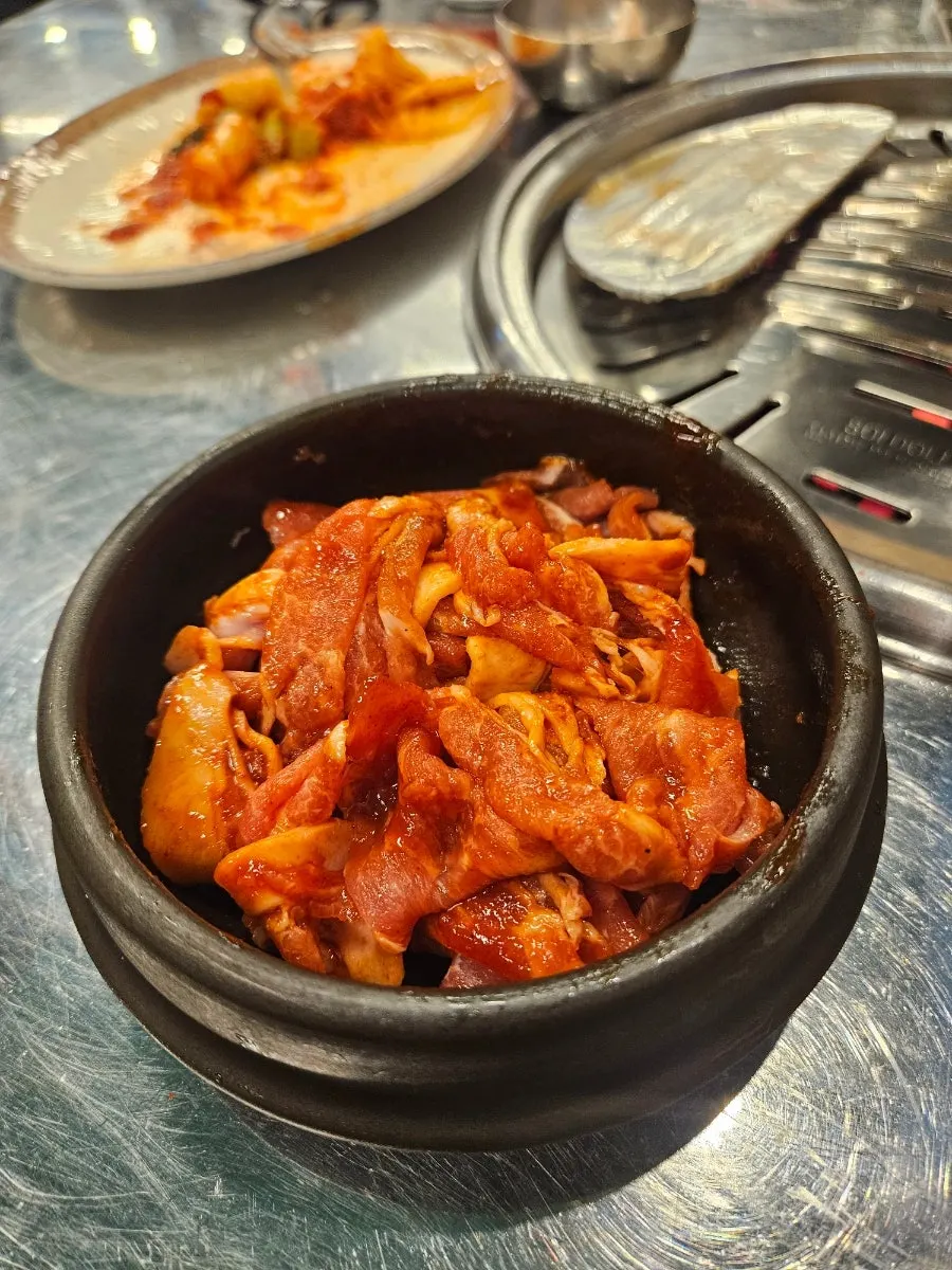 Mixing the gochujang bulgogi with sauce in the jar