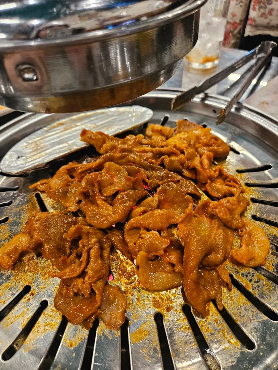 Gochujang charcoal bulgogi laid all at once on the charcoal grill