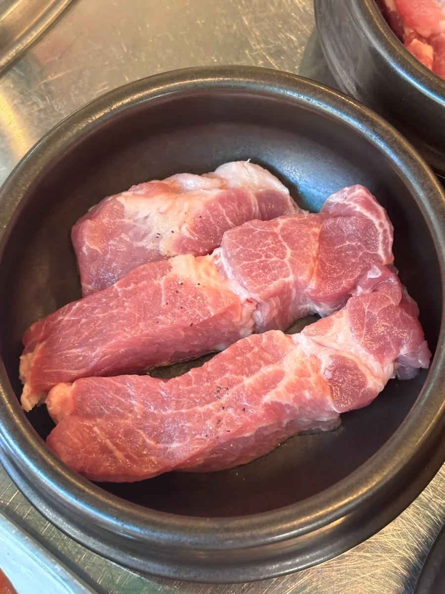 Raw meat plated in a jar