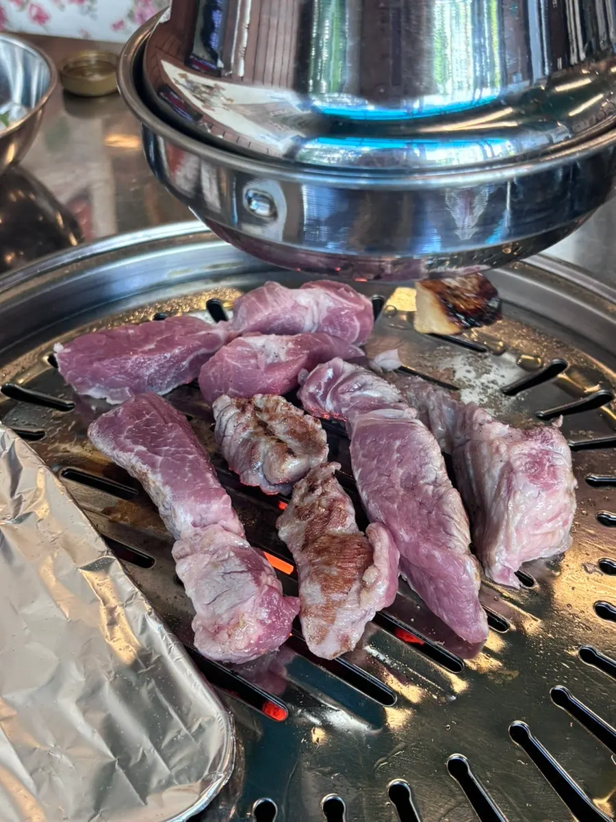 Meat searing golden over the charcoal grill