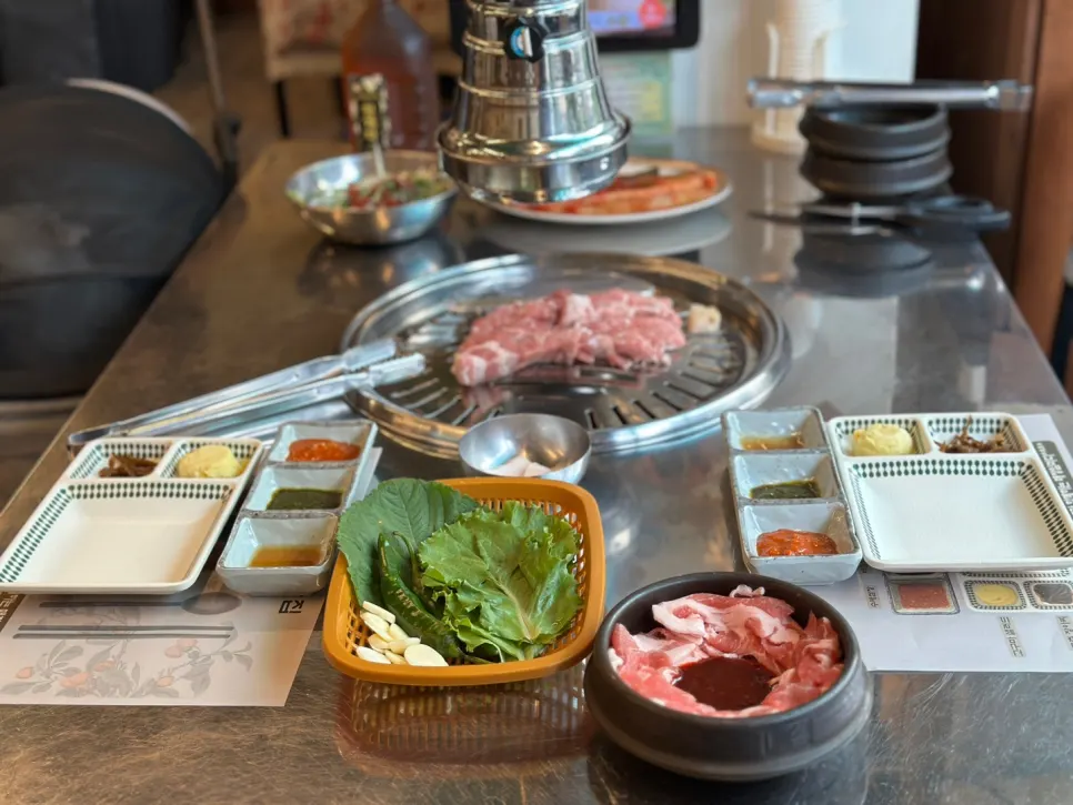 Thick strips of teukmoksal lined up on the grill