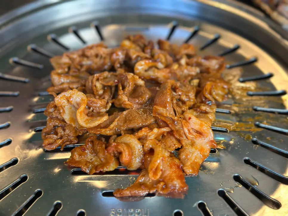 Gochujang charcoal bulgogi poured onto the grill all at once