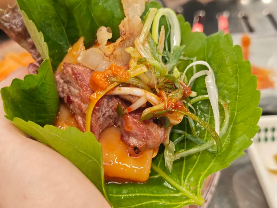 Charcoal-grilled pork belly wrapped in a perilla leaf