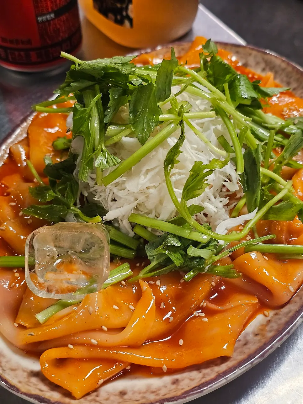 Flat bibim-myeon served alongside the grilled meat
