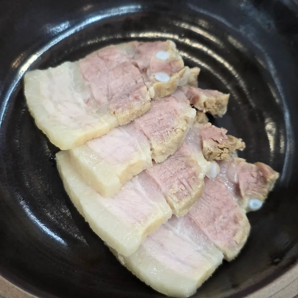 수육을 쌈으로 싸 먹는 모습