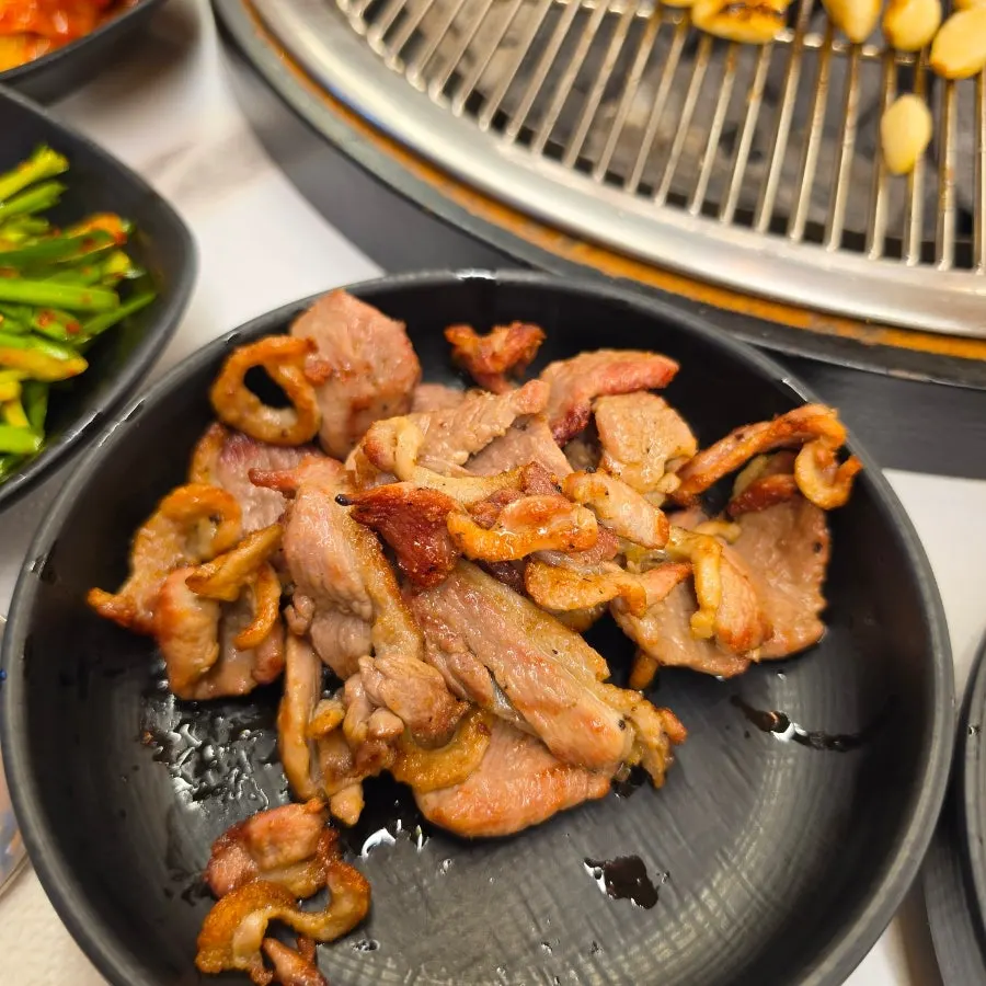 Charcoal-grilled duck turning golden brown