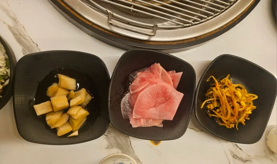 Plates of seasoned bean sprouts and pickled radish