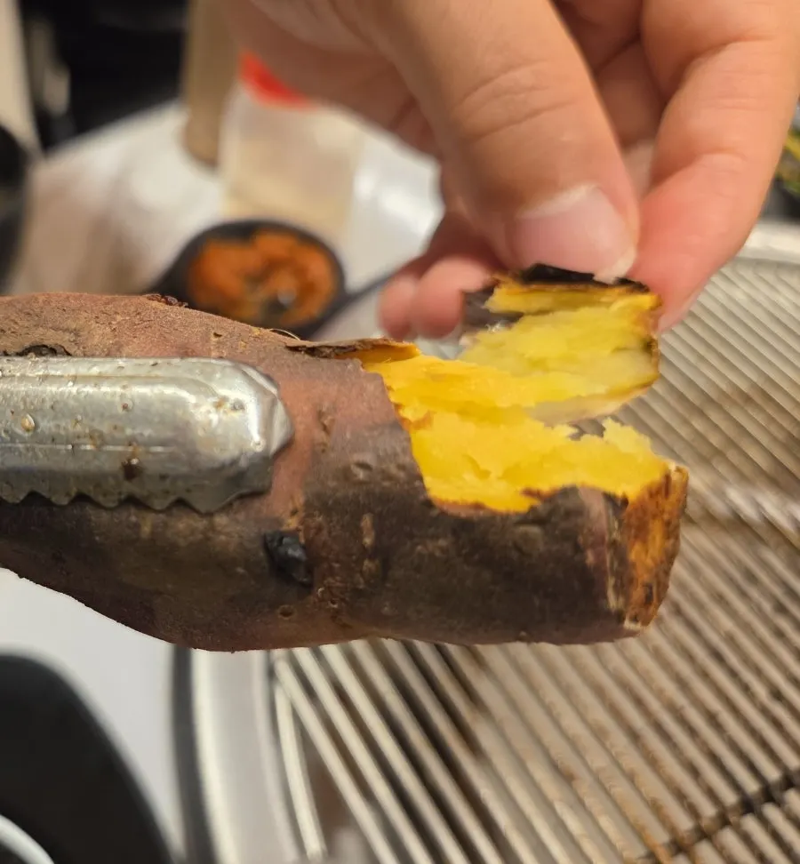 Foil-wrapped sweet potato roasted over charcoal