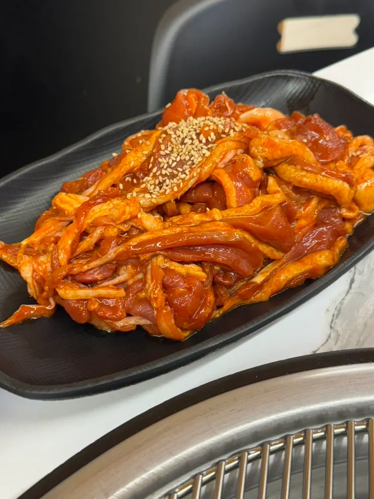 Neatly arranged banchan spread including bean sprouts, pickled radish, and pickled onion