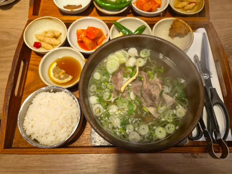 Side dishes of pickles, kimchi, cheongyang peppers, garlic, and doenjang