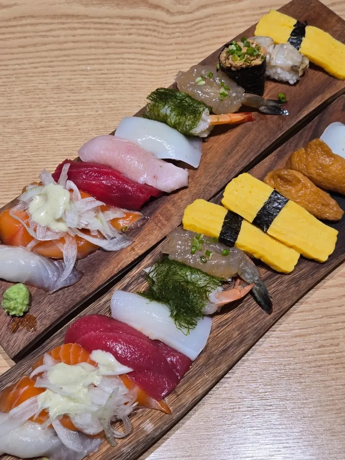 Two plates of Ganghan Sushi and Ganghan Special Sushi set on the table