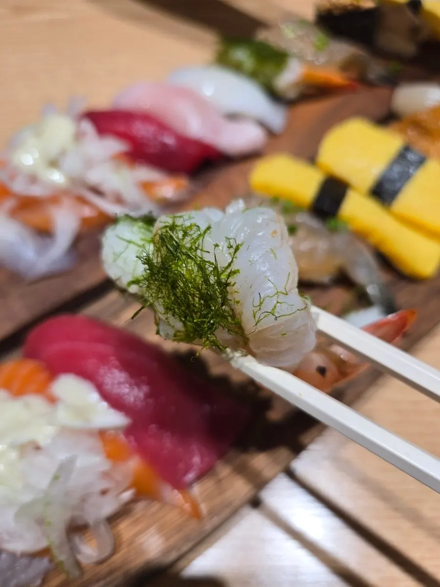 A sushi platter with various types of fish toppings