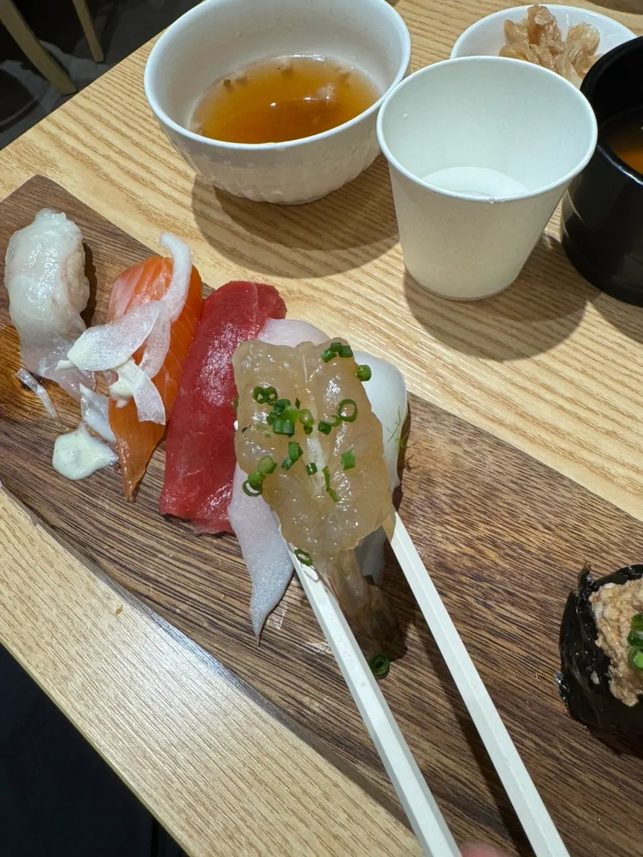Soy sauce shrimp sushi topped with green onion