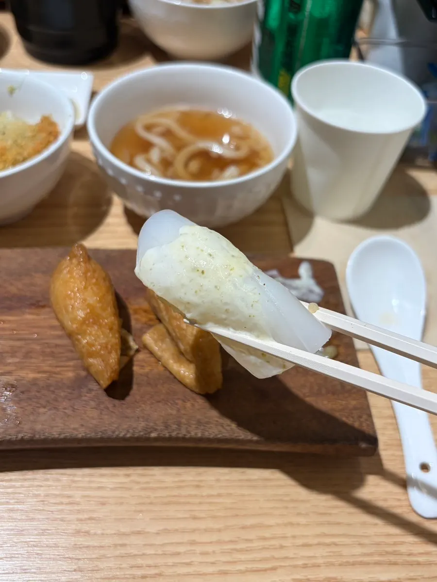 Fried tofu sushi and sauce-topped squid sushi