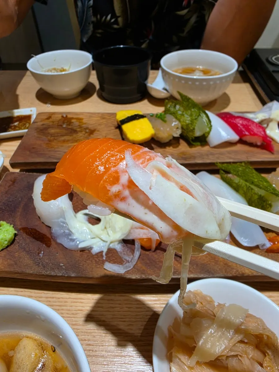 A plate with an assortment of different sushi types