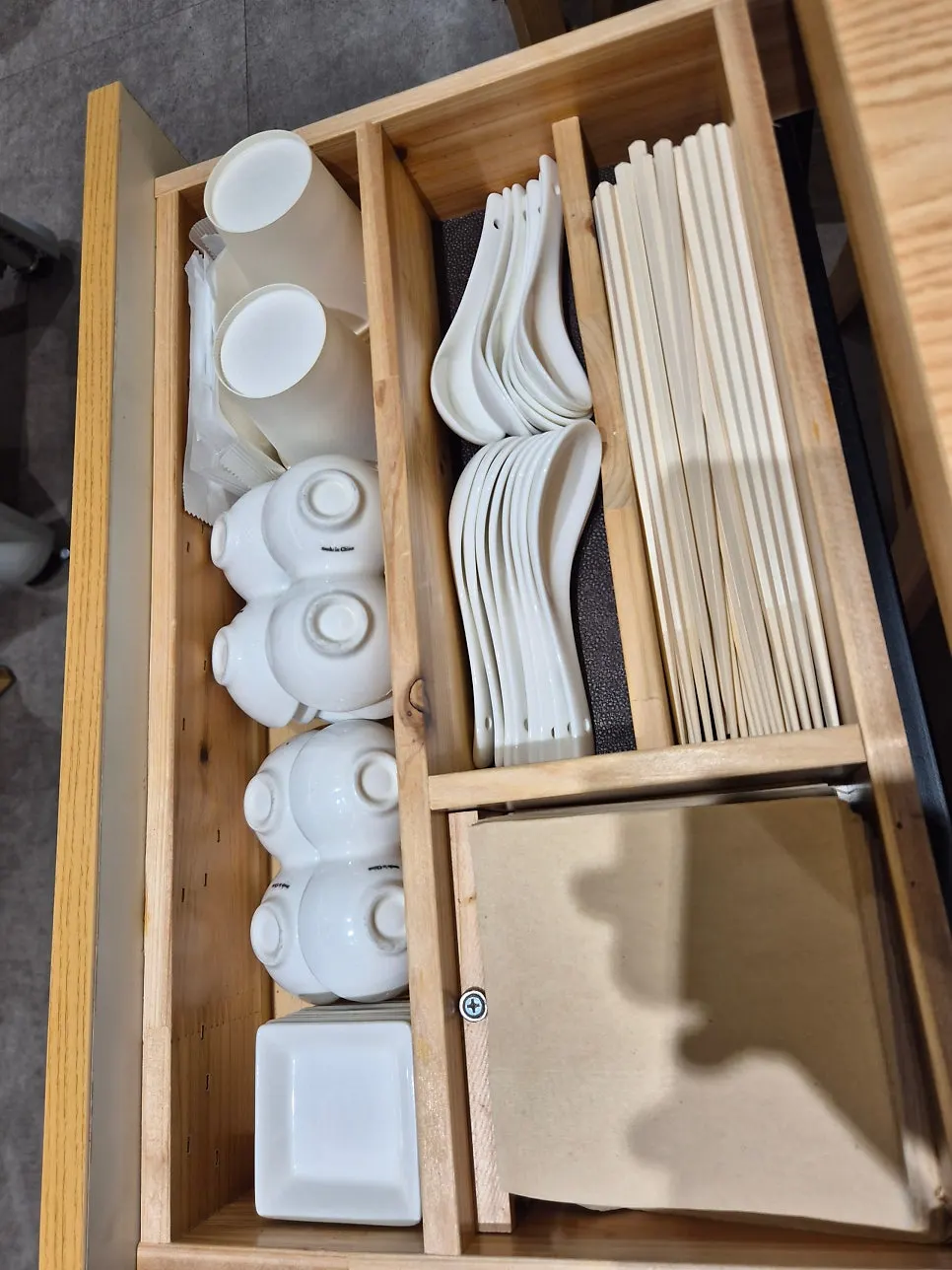 Plates, cups, and small side plates organized in one corner