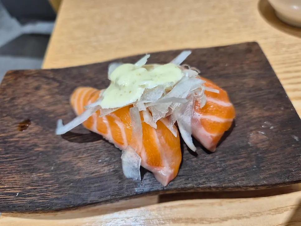 Two pieces of raw salmon sushi ordered as an add-on
